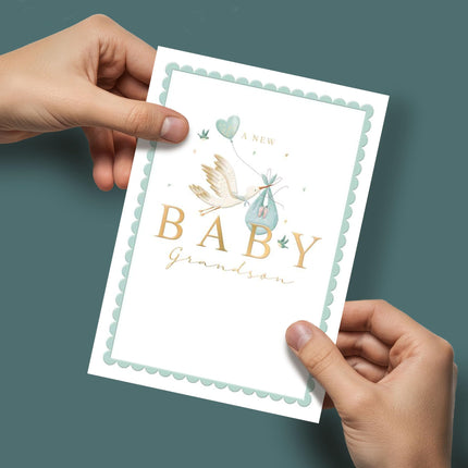 Congratulations Card for New Baby Grandson - Cute Blue Stork & Love Heart Balloon - Embossed Gold Foil Finish - Premium Special Arrival Greeting Card with Envelope